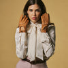 Women’s cognac leather driving gloves, perforated knuckles and buttoned wrist straps