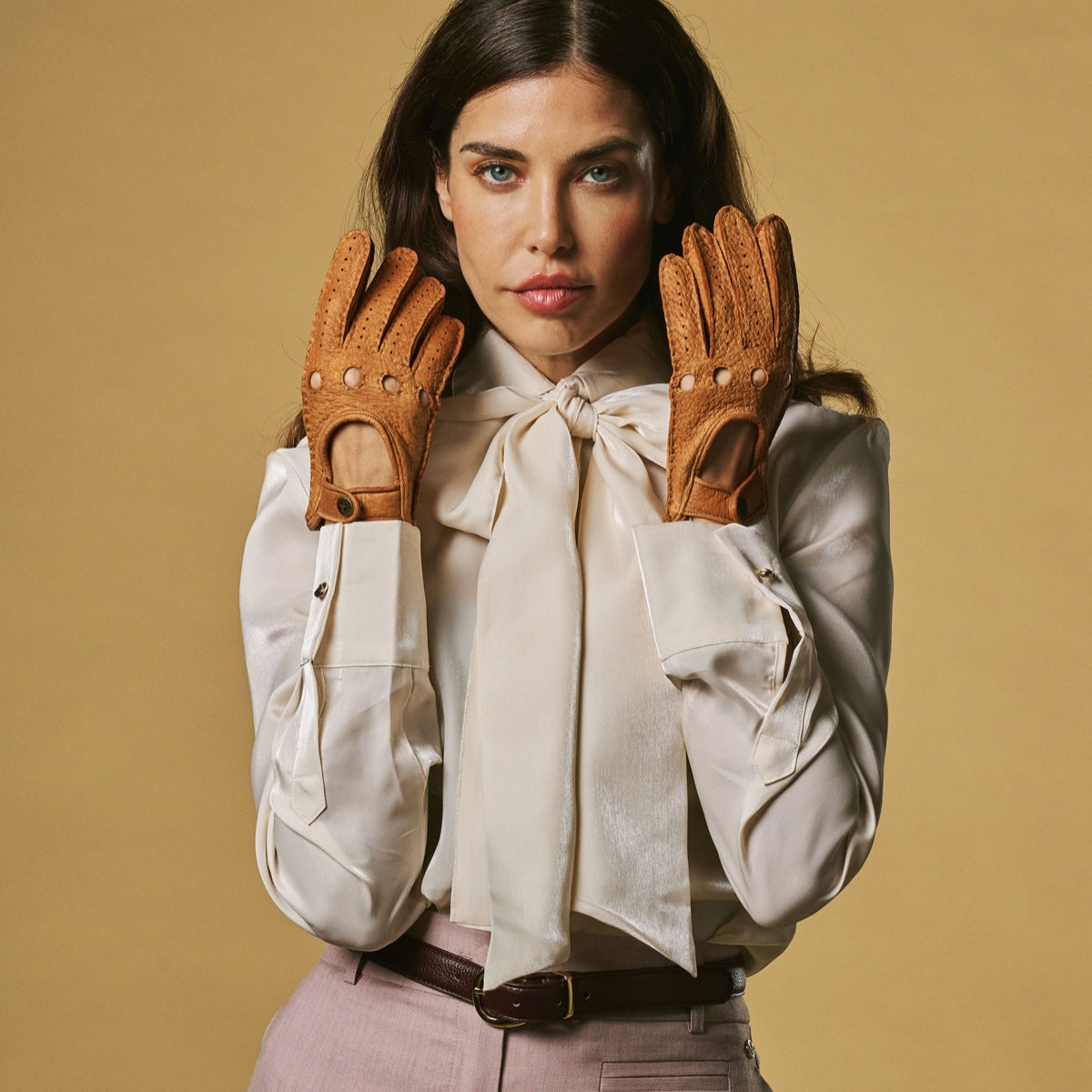 Women’s cognac leather driving gloves, perforated knuckles and buttoned wrist straps