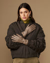Taupe lambskin leather gloves with gold-tone buckle straps on the cuffs