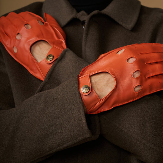 Orange leather driving gloves with stitched knuckles and touchscreen fingertips