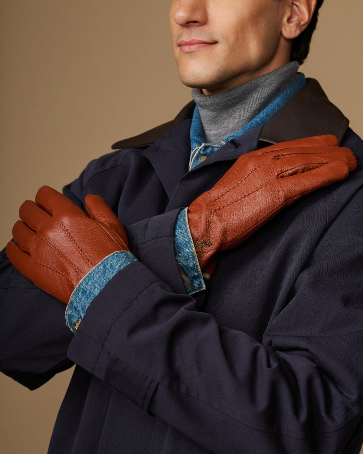 Cognac goatskin touchscreen gloves with wool lining, worn with dark coat