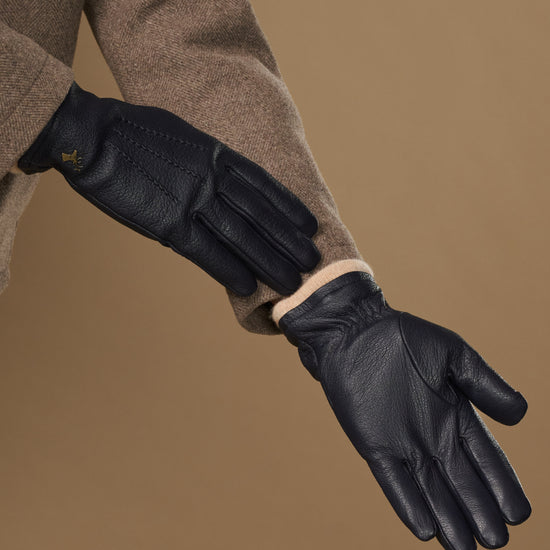Men's navy goatskin leather gloves with wool lining, side view of knuckles and cuff