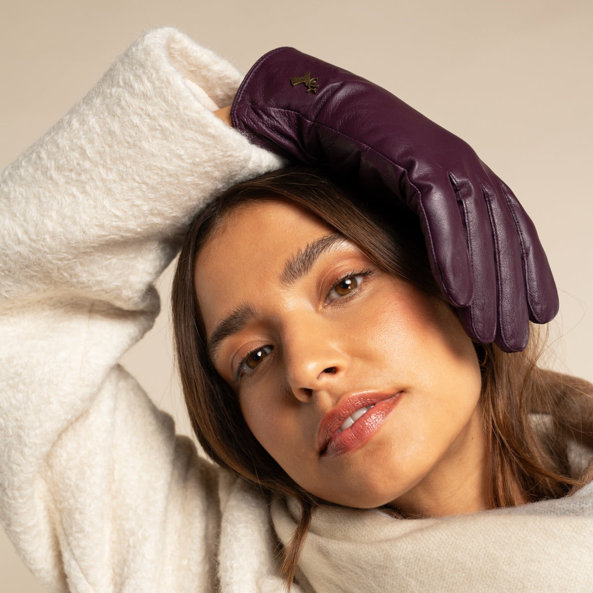 Purple leather gloves styled with a cozy knit sweater
