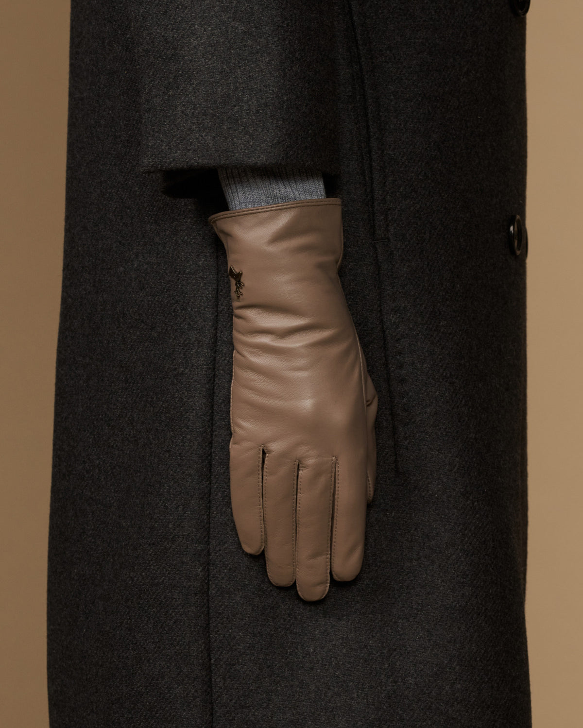 Women’s taupe leather gloves, side view with finger panels and stitched cuff