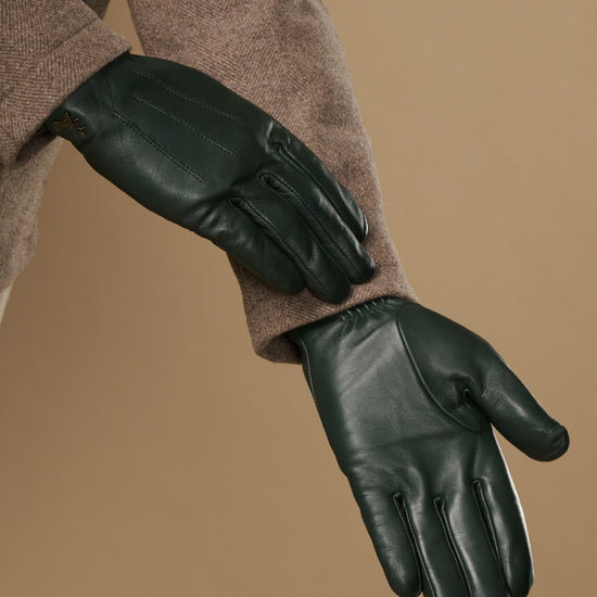 Dark green Jake sheepskin gloves with warm fleece lining, side view on sleeve cuff