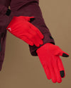 Red lightweight activity gloves showing textured grip palms and black touchscreen fingertips