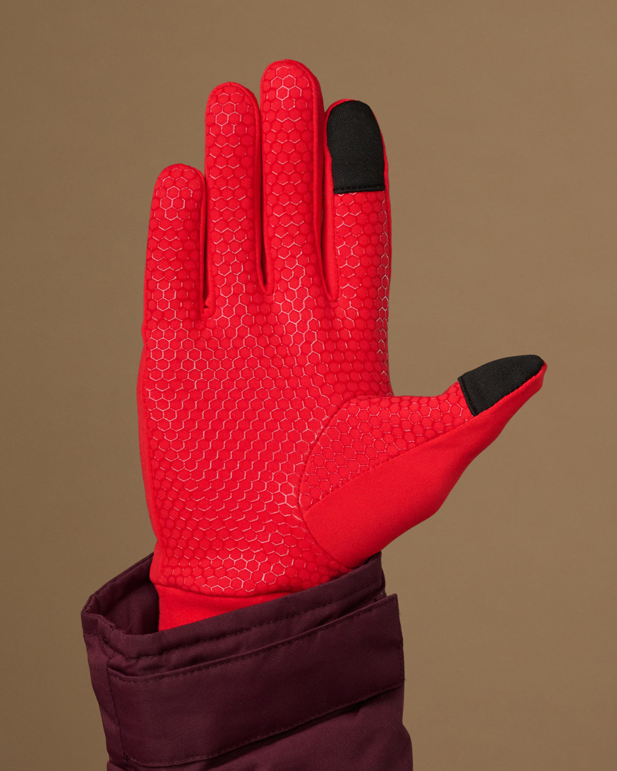 Red activity glove with textured grip palm and black touchscreen fingertips