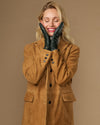 Dark green leather gloves with silk lining, finger seams, and touchscreen-compatible tips