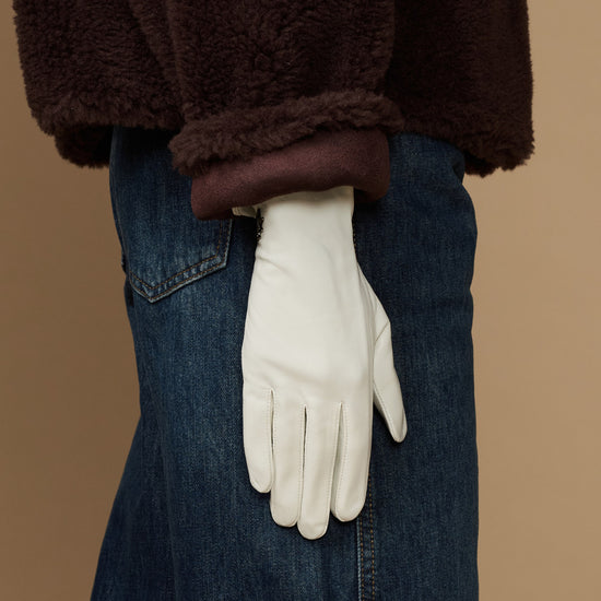 White leather glove with clean wrist seam and full hand coverage, tapered cuff