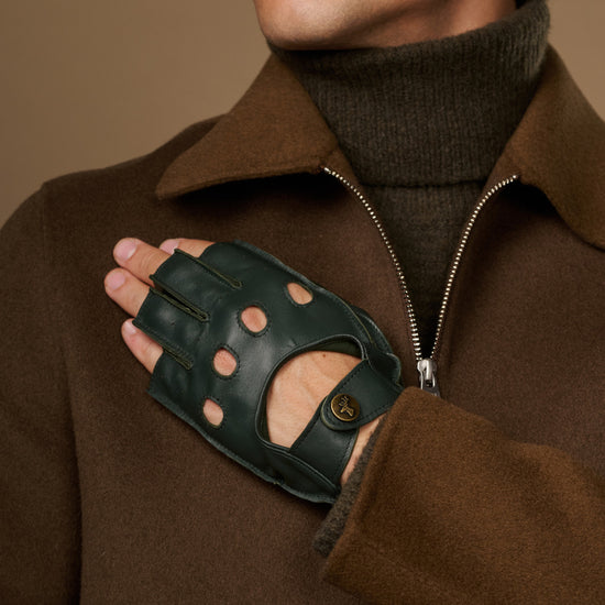 Dark green lambskin glove with fingerless tips, perforated knuckles, and a buttoned wrist strap