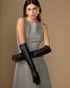 Women’s black leather elbow gloves, both hands posed with stacked glove overlap