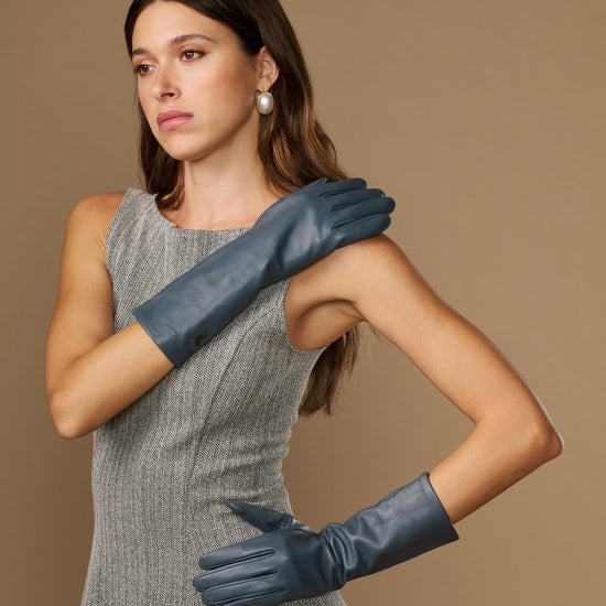 Grey mid-forearm leather gloves with smooth finish and fitted finger seams