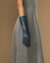 Single grey-blue mid-forearm leather glove with stitched palm and finger panels
