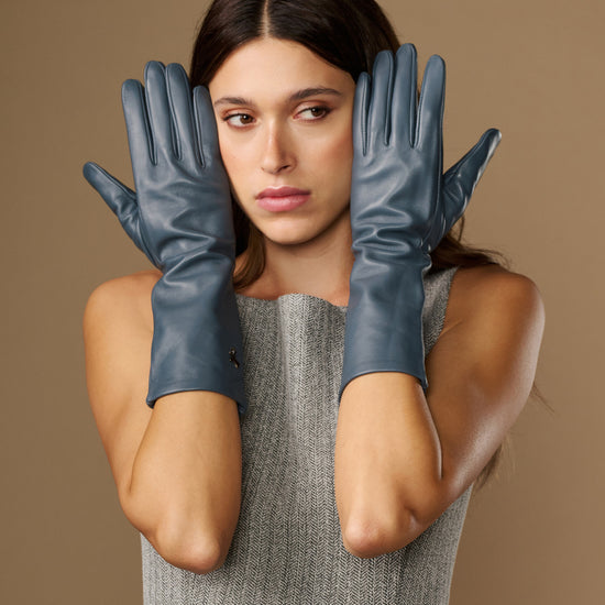 Pair of grey-blue mid-forearm leather gloves with glossy leather texture