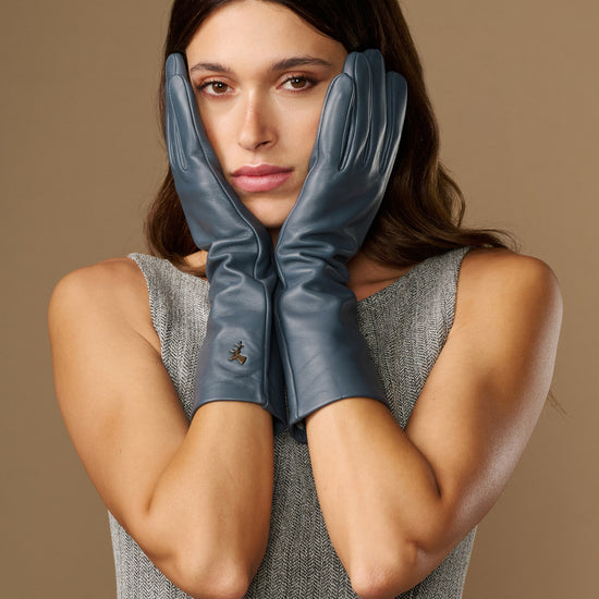 Grey-blue leather gloves, mid-forearm length, with glossy finish and stitched fingers