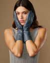 Grey-blue leather gloves, mid-forearm length, with glossy finish and stitched fingers
