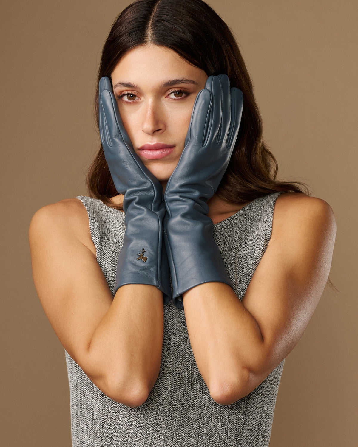 Grey-blue leather gloves, mid-forearm length, with glossy finish and stitched fingers