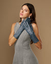 Grey-blue mid-forearm leather gloves with smooth surface and contoured finger tips