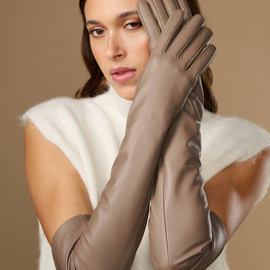Close-up of taupe lambskin leather gloves with long cuffs and stitched fingers