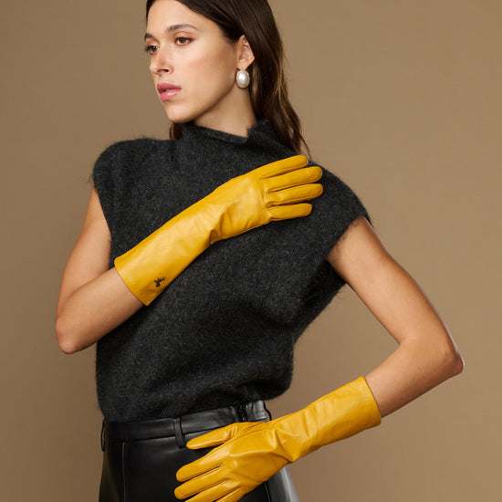 Yellow mid-forearm leather gloves with smooth finish and stitched finger panels