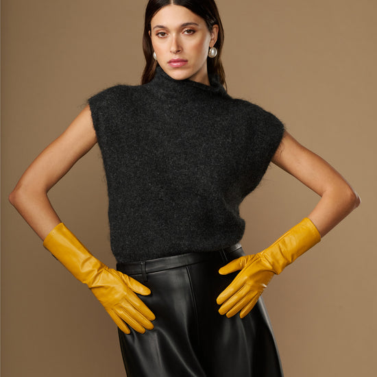 Pair of yellow mid-forearm leather gloves with tapered cuffs and stitched fingers