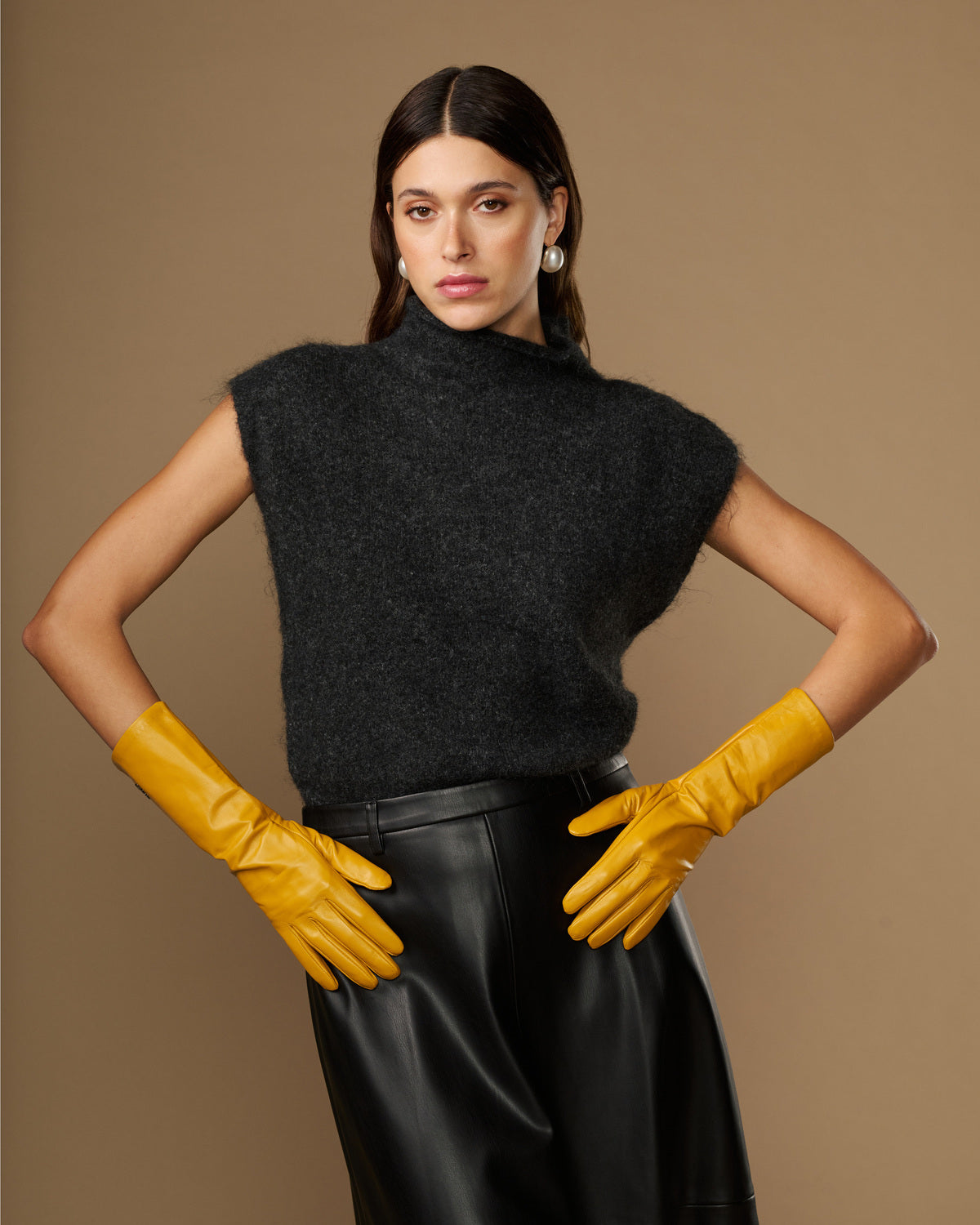 Pair of yellow mid-forearm leather gloves with tapered cuffs and stitched fingers