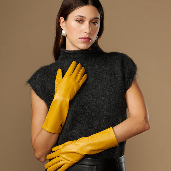 Yellow mid-forearm leather gloves with smooth finish and stitched finger panels
