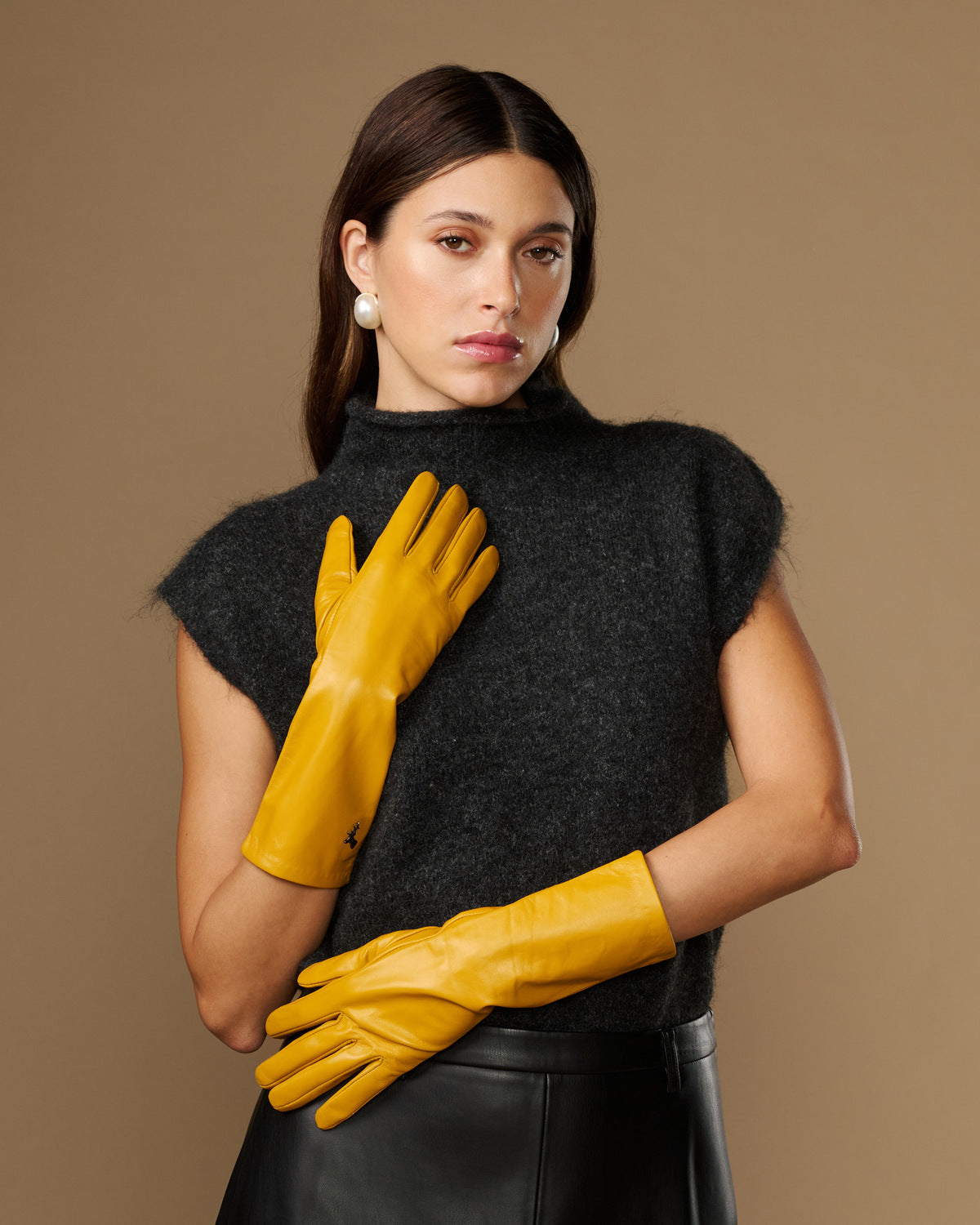 Yellow mid-forearm leather gloves with smooth finish and stitched finger panels