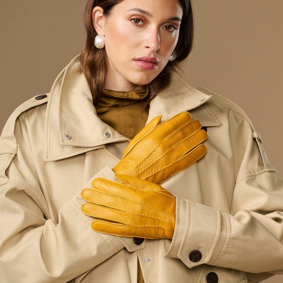 Yellow deerskin leather gloves with stitched knuckles and snug wrist cuff
