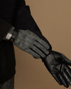 Men's gloves with gray herringbone interior and black leather hand section and cuff.