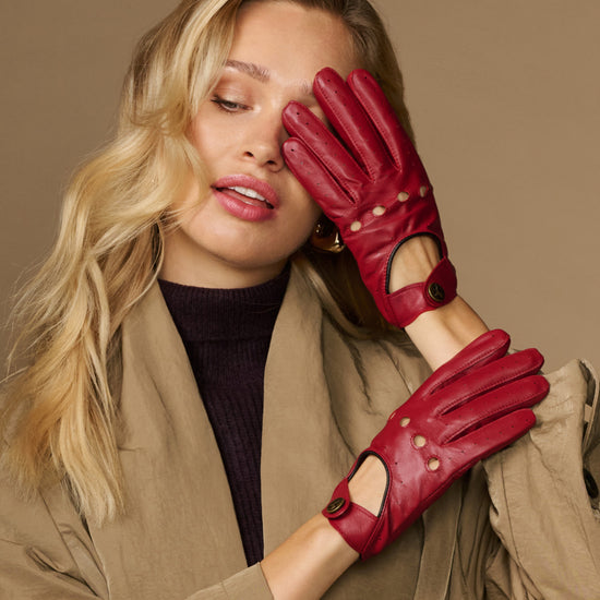Women’s red leather driving gloves with elastic wrist and decorative studs