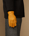 Yellow goatskin leather gloves, back view with stitched seams and gray cuff